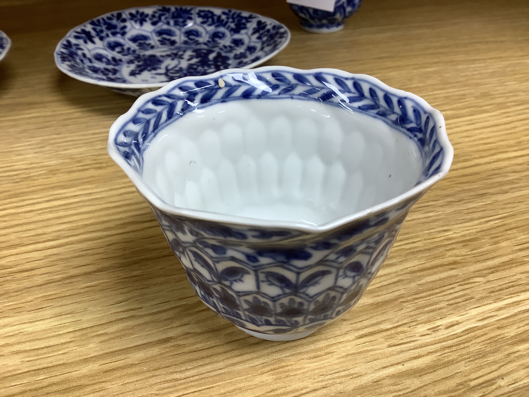 A Chinese blue and white plate 13cm diameter, a similar tea bowl and saucer, Kangxi period and a 19th century Chinese blue and white bottle vase